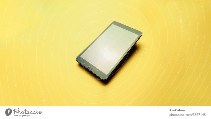 Tablet over a yellow background with copy space and a minimal design phones copy-space selection tech listen multimedia workplace screen middle working mic