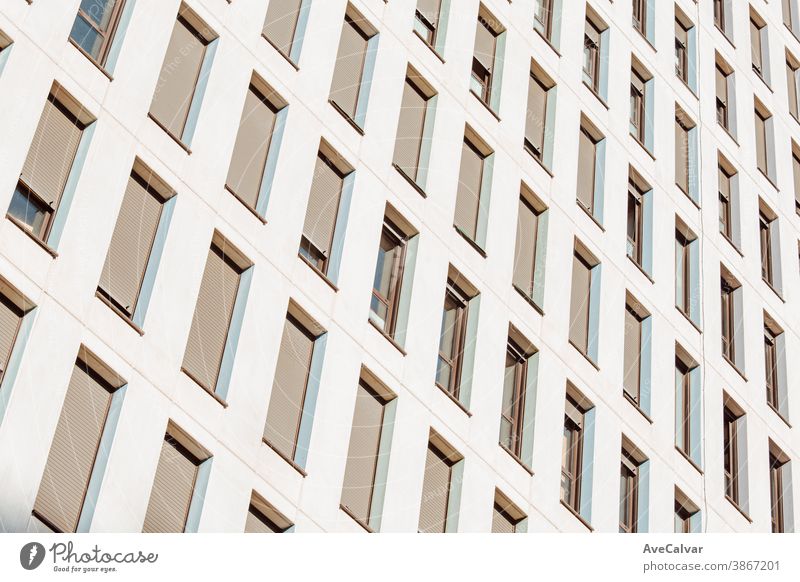 Symmetrical close up of a wall of windows on a building with copy space and design skyscraper symmetry growth futuristic horizontal business color image