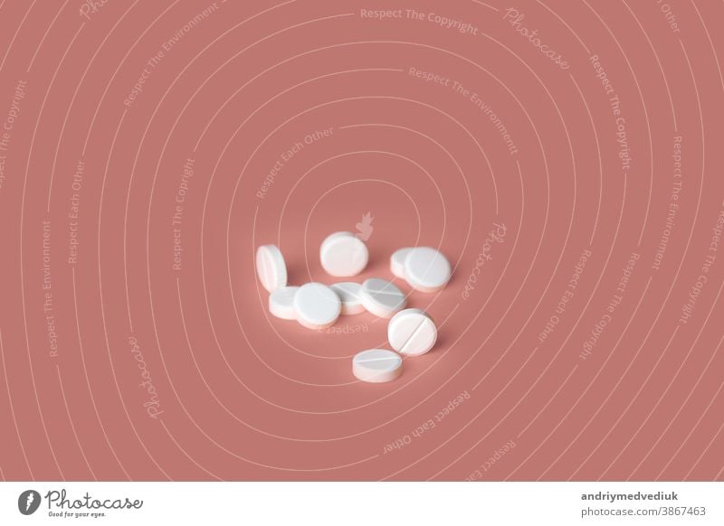 Group of white medical pills isolated on pink background. selective focus. concept of health drug healthy tablet prescription medicine care vitamin capsule