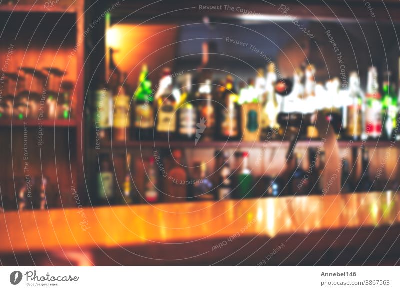 Classic bar counter with bottles in blurred background, copy space or space for text. colorful defocused background restaurant or cafe table light interior