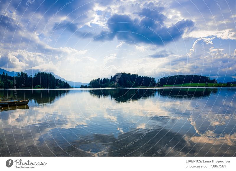Cloudy blue sky and its mirroring background boat clear cloud cloudy color colorful copy space day daylight direction lake nature outdoor outdoors reflections