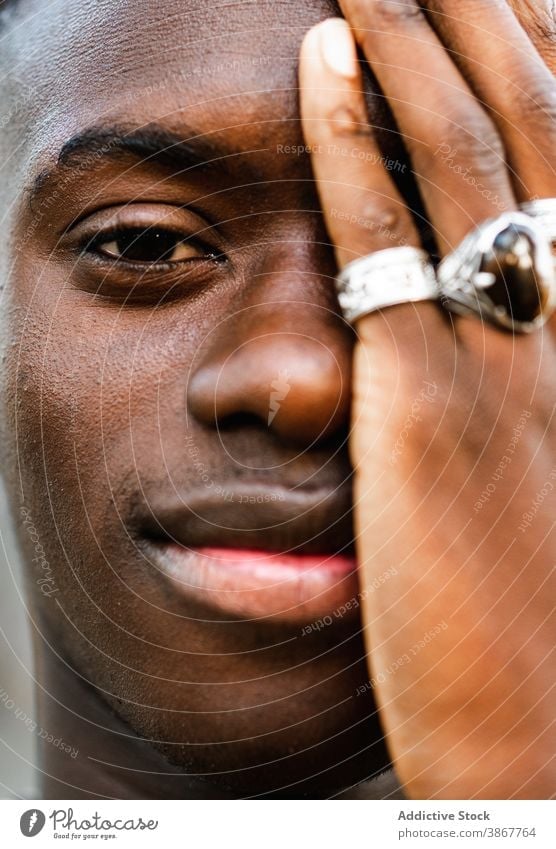 Cheerful black man looking at camera cheerful portrait handsome individuality smile appearance young millennial happy male ethnic african american trendy ring
