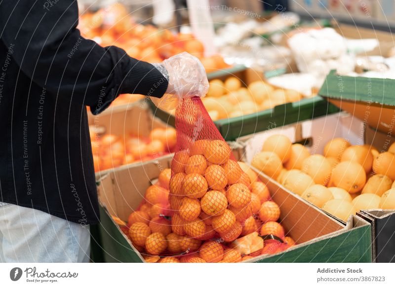 Buyer in protective gloves choosing fruits in supermarket coronavirus customer infection pandemic safety grocery buyer covid 19 covid19 prevent epidemic