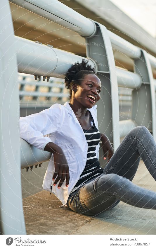 Smiling African American woman resting on street smile cheerful happy urban young enjoy positive content afro black female student african american ethnic