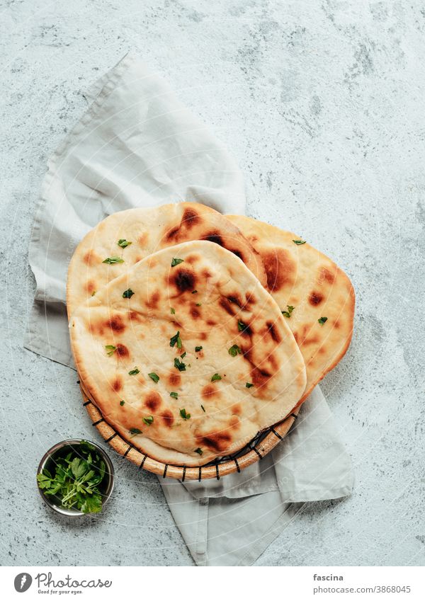 naan flatbreads on gray cement, copyspace vertical naan bread naan texture pita fresh flat-bread circle copy space tasty meal delicious cuisine food cook asian