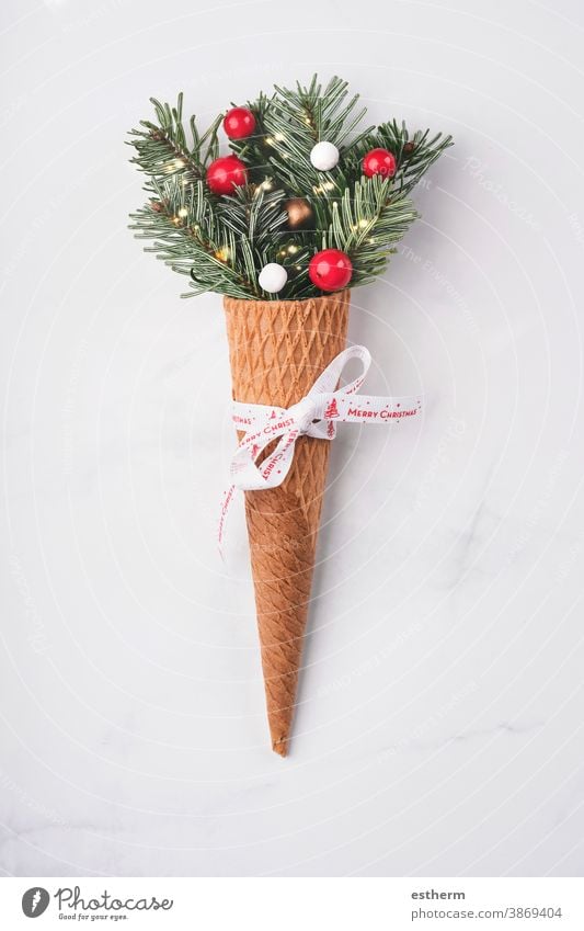 Christmas concept background. Fir branches with Christmas decorations in ice cream cone christmas christmas background Ice cream cone delicious pastry candy