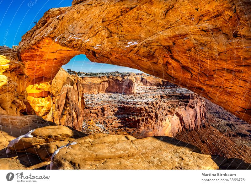 Golden glowing Mesa arch on a sunny winter day in the Arches National Park, Utah usa mesa mesa arch landmark park national utah orange erosion snow canyon rock