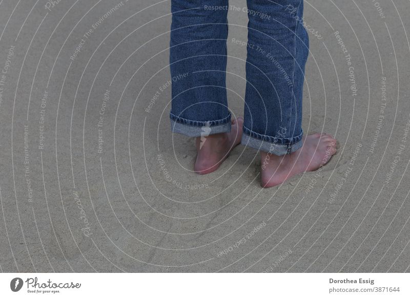 Barefoot in the sand feet naked feet Men's Feet Sand Beach Close-up colored jeans Day Exterior shot Ocean Stand Colour photo