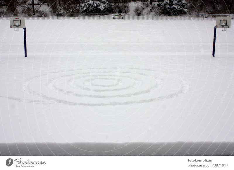 lonely symmetrical tracks in the snow on a sports field Symmetry Snow Snow track Tracks Spiral basketball court Basketball Deserted Basketball basket
