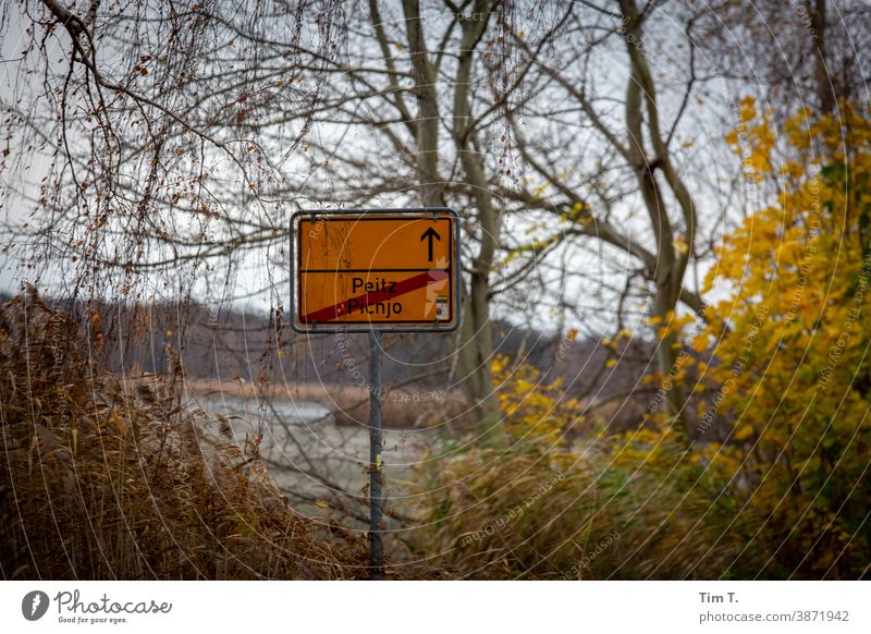 town exit sign Peitz in autumn Lausitz forest Autumn Brandenburg Signs and labeling Town sign Deserted Exterior shot Colour photo Day Street