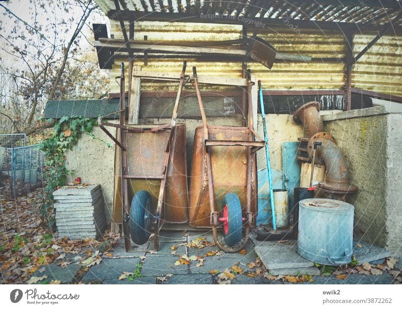 nothing to do Wheelbarrow 2 Wall (building) Wall (barrier) Agricultural machine Living or residing Exterior shot Detail Deserted Evening Orderliness Clean