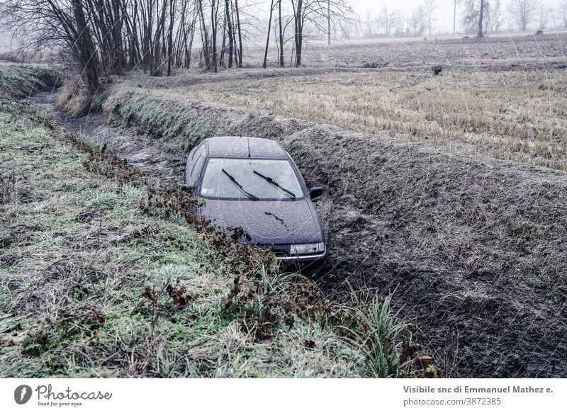 car ended up in a ditch due to ice in north Italy damaged accident crash drift wreck winter broken vehicle behaviour destroyed circulation route surprise