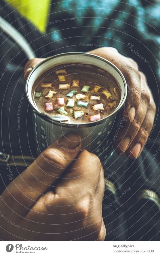 You hold a cup with cocoa / coffee / cappuccino and colourful marshmallows in both hands Cup Coffee cup To have a coffee Cappuccino Hot Chocolate Hot drink