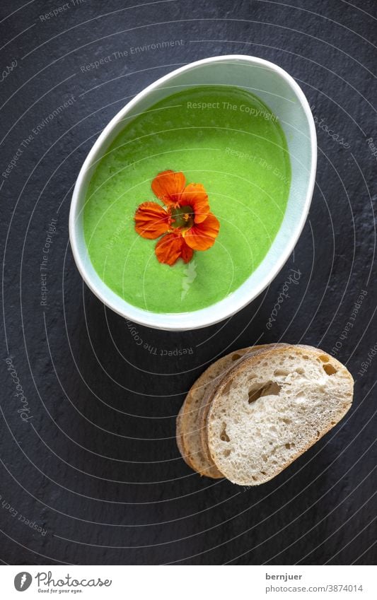 creamy pea soup on black slate Pea soup Creamy Soup Legume Vegetable Puree Oval Delicious Overview of the Slate Black Green salubriously Eating Dinner boil