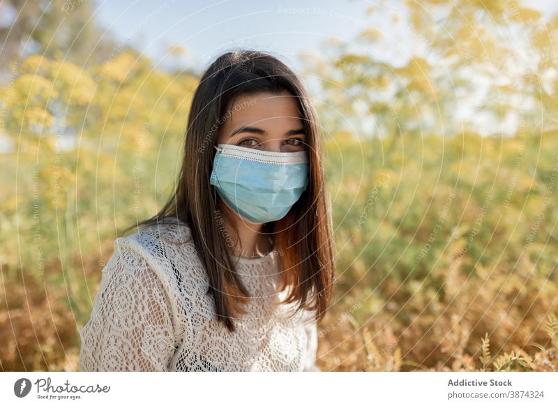Woman in medical mask in field woman coronavirus new normal nature protect prevent female sunny safety calm covid contagious viral hazard covid19 danger lady