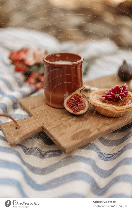 Tasty food on wooden board for picnic blanket sweet drink dessert cocoa tartlet park delicious tasty beverage yummy timber meal cutting board chopping board fig