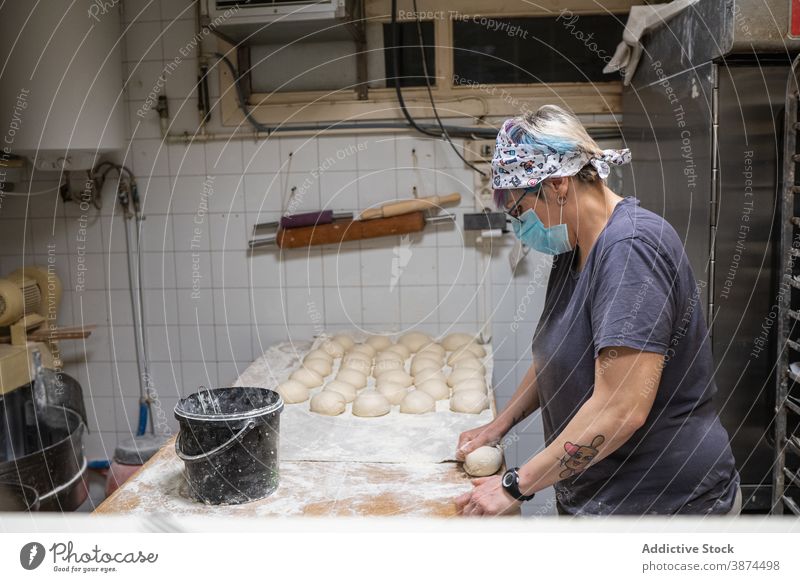 Woman shaping dough in buns in bakery shape raw woman bakehouse round mask new normal female coronavirus form pastry recipe cuisine ingredient flour culinary