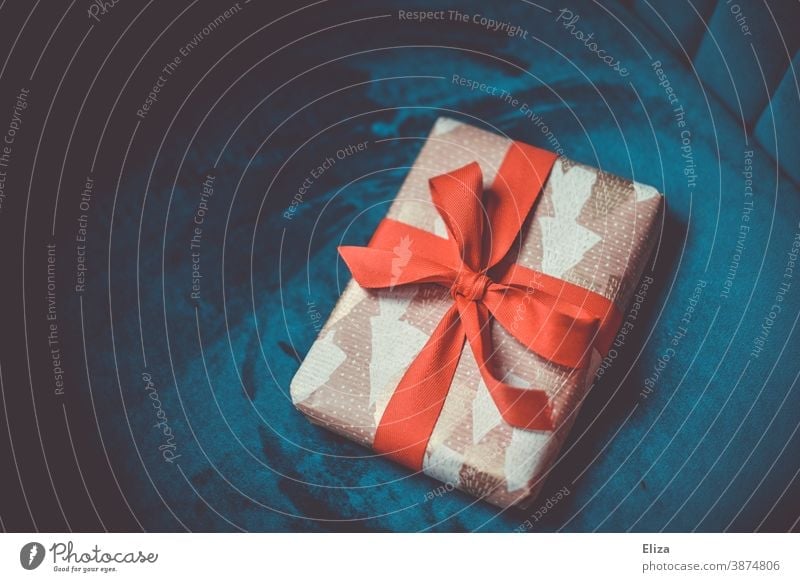 Christmas present with red ribbon on blue background Gift Christmas gift Bow Red Blue Packaged Christmassy christmas eve Donate Christmas & Advent