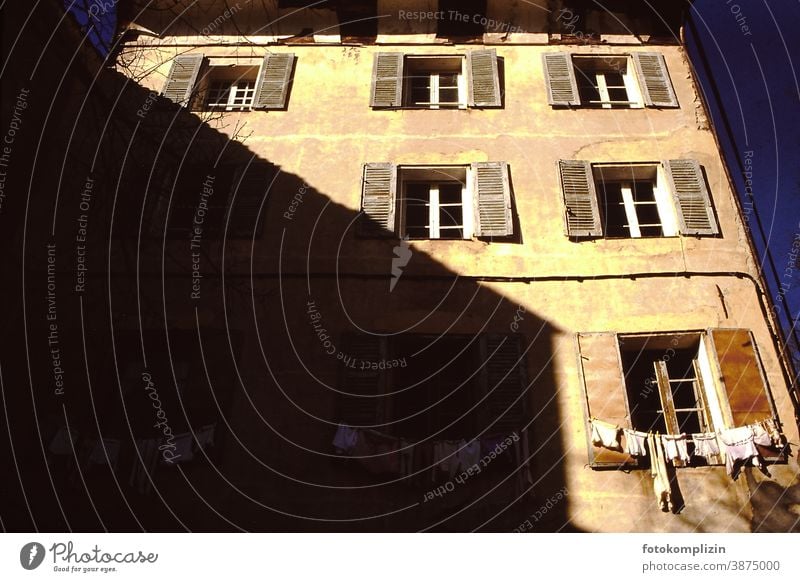 französische Altbaufassade mit Wäscheleine vor dem Fenster Fassade wäscheleine bauwesen architektur alt haus Gebäude babywäsche schatten hausschatten Haus