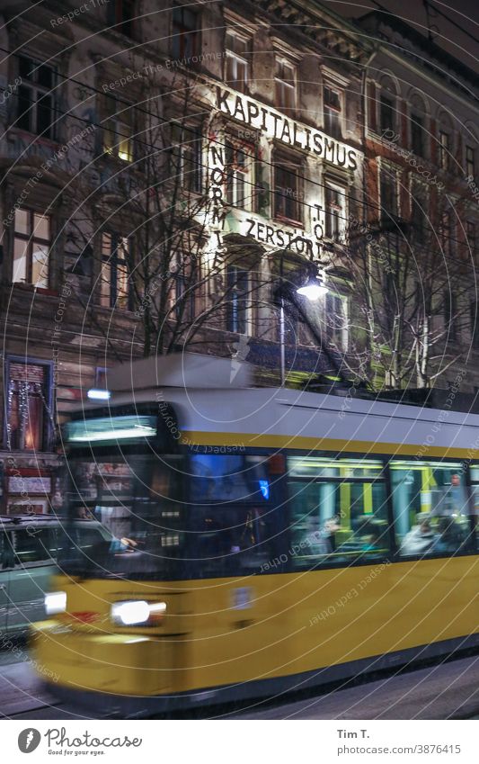 a tram drives through the picture in the Kastanienallee at night Berlin Prenzlauer Berg chestnut avenue Colour photo Night Winter tramway Exterior shot