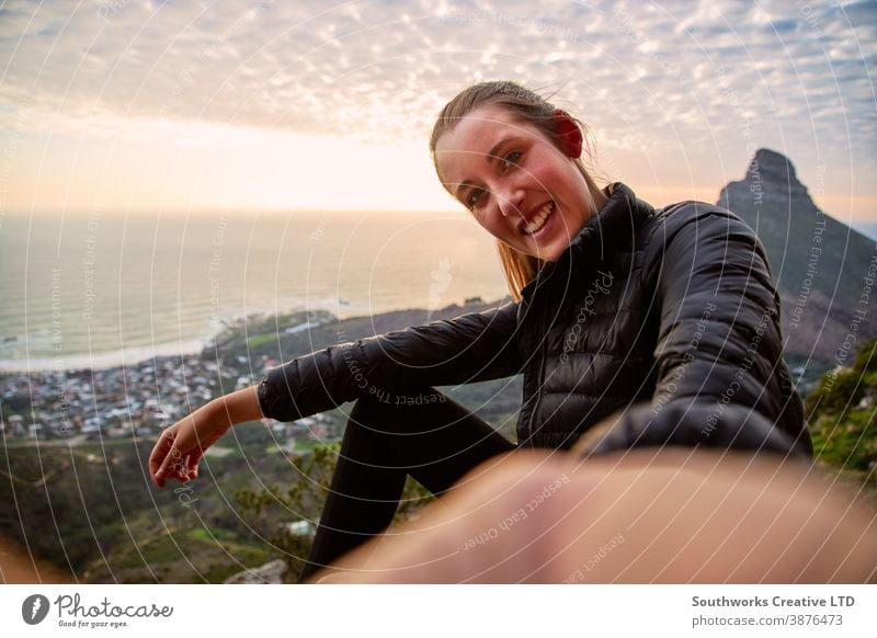 Young Woman With Backpack Hiking Along Coastal Path Posing For Social Media Selfie On Mobile Phone selfie taking photo woman influencer sunset young women hike