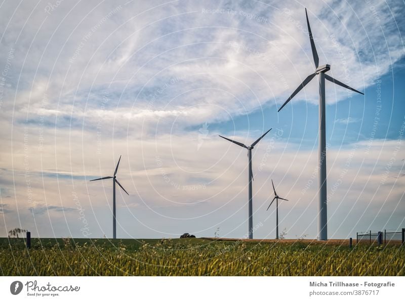 Wind turbines on the field Wind energy plant windmills Renewable energy Technology Energy industry Agriculture sustainability Electricity stream Fence Field Sky