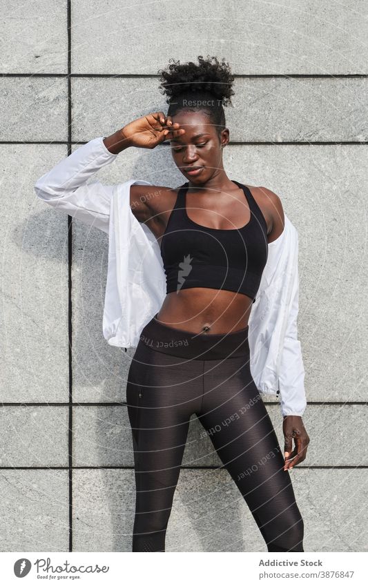 Black slim sportswoman training in city exercise street athlete female ethnic black african american sportswear wellness energy workout urban motivation