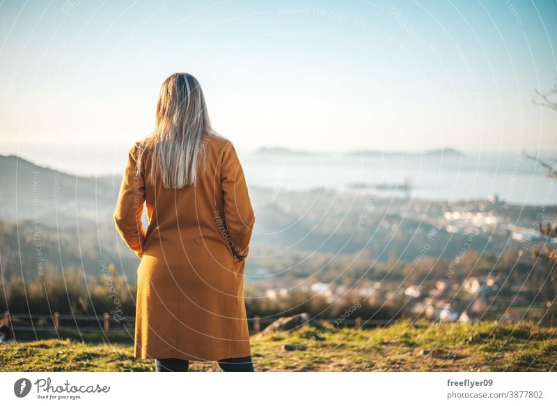 Woman on a yellow coat contemplating the landscape woman winter autumn vigo galicia nature outdoors freedom sunset contemplation sky coolness countryside leaf