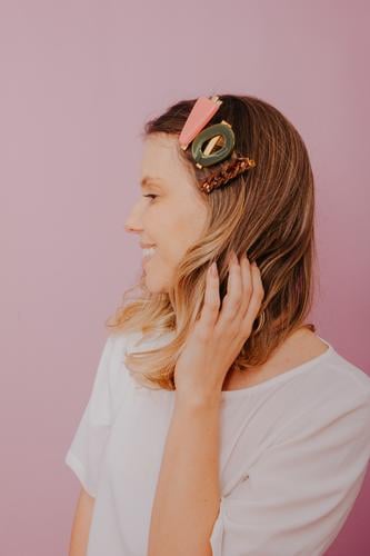 Blonde Woman with Clips in her hair, modern hair pins, pink background accessories blonde clip close-up copy space editorial fashion fashion photography