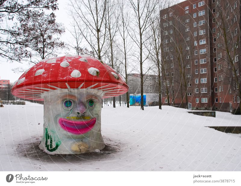 Neighborhoods can be poisonous on the square Playground Amanita mushroom Comic Winter Cold Prefab construction Facade Snow bare trees Sky smeared Quarter