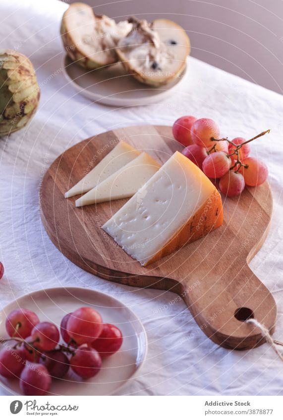 Fresh fruits and cheese arranged on table assorted serve various product arrangement dairy appetizer delicious tasty fresh anona grape food palatable organic