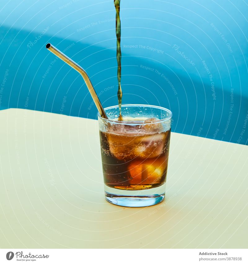 Glass of cold soda with metal eco friendly straw on table zero waste glass drink refreshment cola concept reuse clean supply tool material object cool beverage