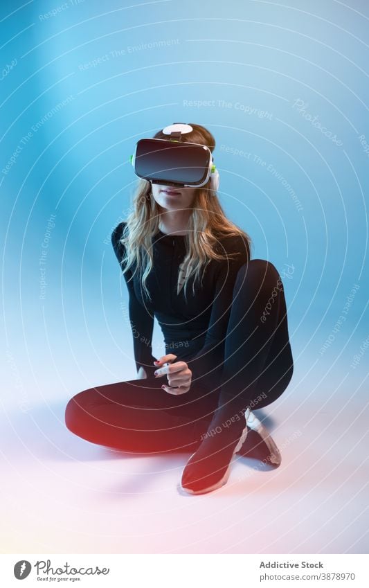 Anonymous young woman having VR experience vr headset technology device virtual reality modern innovation entertainment video futuristic simulation hi-tech