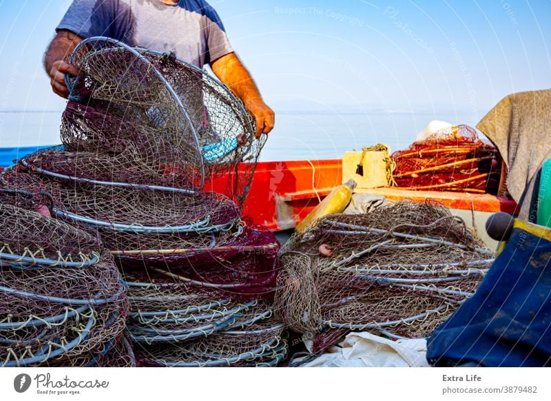 https://www.photocase.com/photos/3879482-fisher-pile-up-fishing-net-on-the-beach-along-photocase-stock-photo-large.jpeg