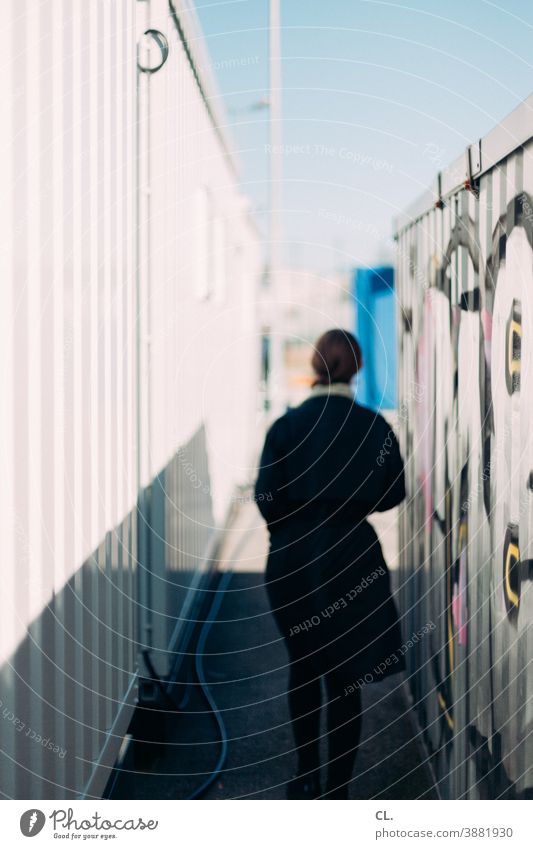 between containers Container Woman Rear view Anonymous Identity Graffiti Mysterious Movement Going Pursue on one's own Lanes & trails out blurred