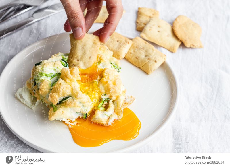 Traditional cloud eggs with vegetables for breakfast yolk dip eat cracker food healthy homemade delicious tasty yummy meal hand dish morning nutrition cuisine