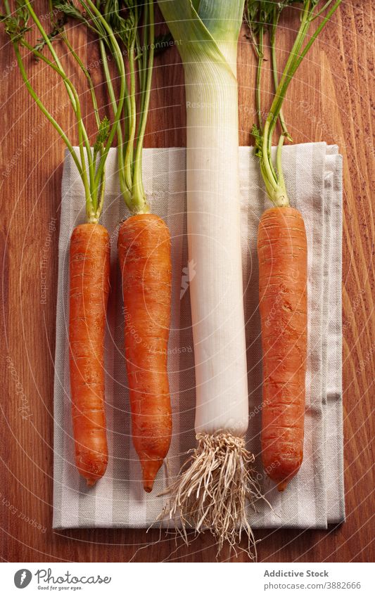 Fresh carrots and leek on table vegetable fresh set food natural organic raw healthy vitamin nutrition ripe ingredient vegan vegetarian color culinary meal