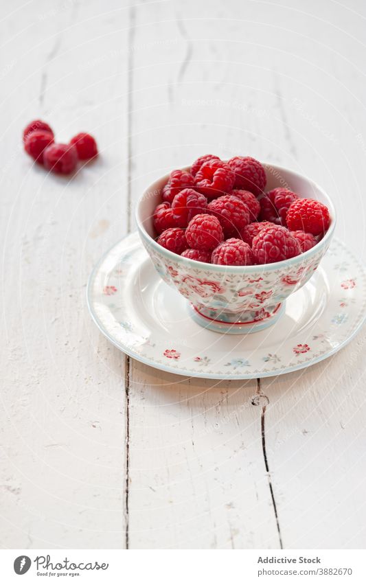 Ripe raspberries in bowl on wooden table raspberry fresh ripe breakfast aromatic food natural healthy summer white plank red delicious tasty meal serve dessert