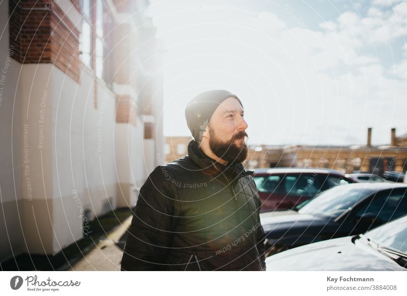 bearded man dressed in winter clothes adult attractive car caucasian cheerful city clothing cold enjoying exterior fashion fashionable freedom frost frozen guy