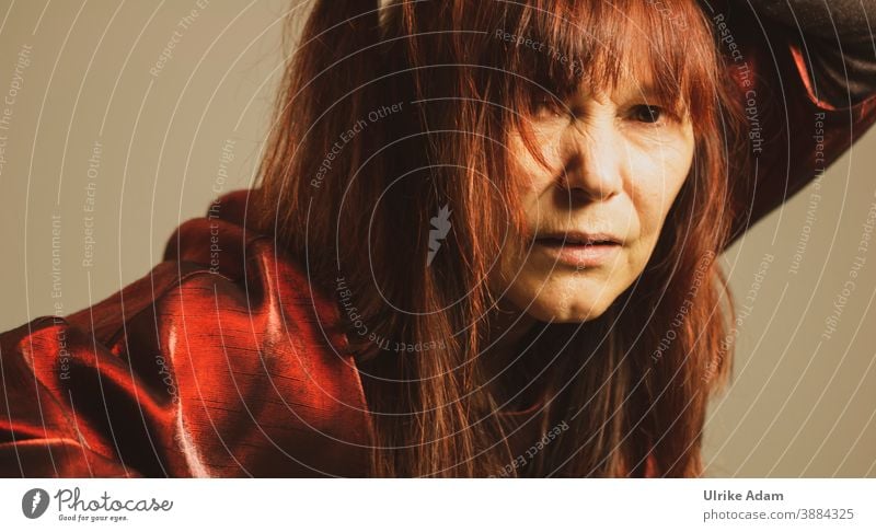 Woman with red long hair looks sceptically ........ Long-haired Feminine Human being Red-haired Skeptical Looking into the camera Adults Interior shot portrait
