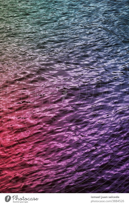 multi colored lights reflected on the water reflection bright liquid multicolored colorful colors abstract textured background pattern ripple wave clear surface
