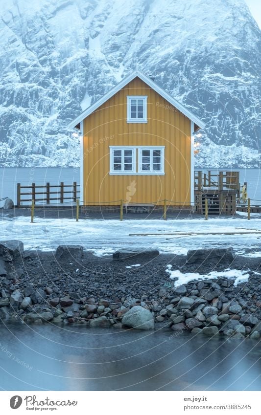 Yellow cabin by the fjord in Reine on the Lofoten Hut House (Residential Structure) Rorbuer Fishermans hut Vacation home Lofotes Norway Reinefjorden Winter Snow