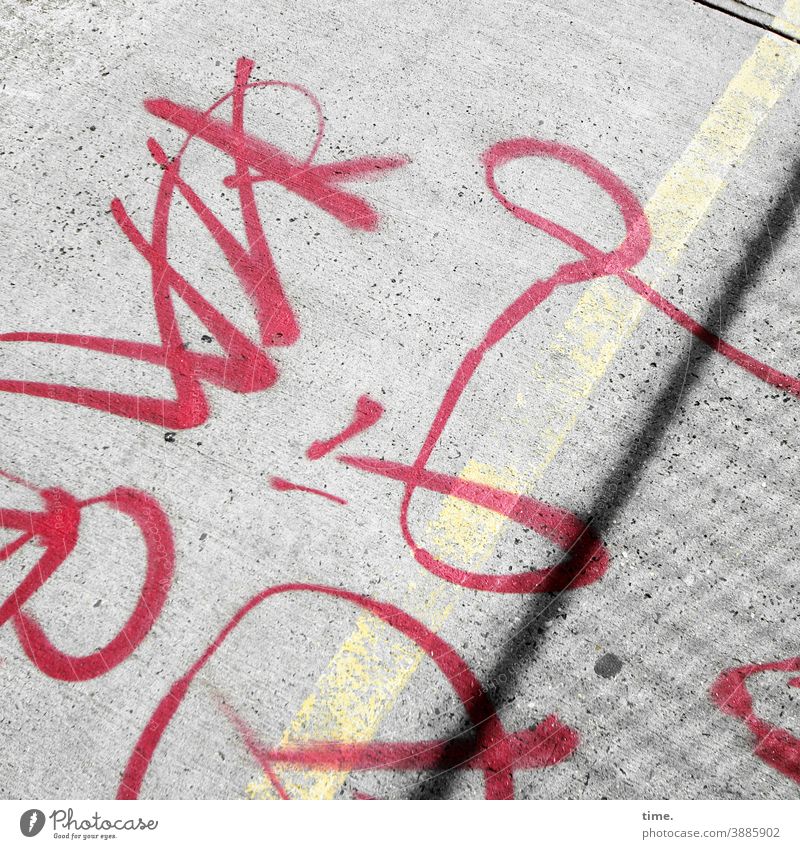 system relevant | characters Characters writing Text Ground Street sales Driveway Sidewalk Red Line Word graffiti symbol Sign Hard sunny Coating embassy