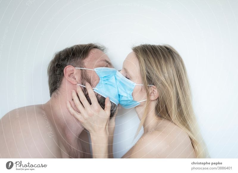 Man and woman kiss with mask Woman Mask mouth-nose protection corona covid-19 COVID coronavirus pandemic Corona virus Protection Risk of infection Virus