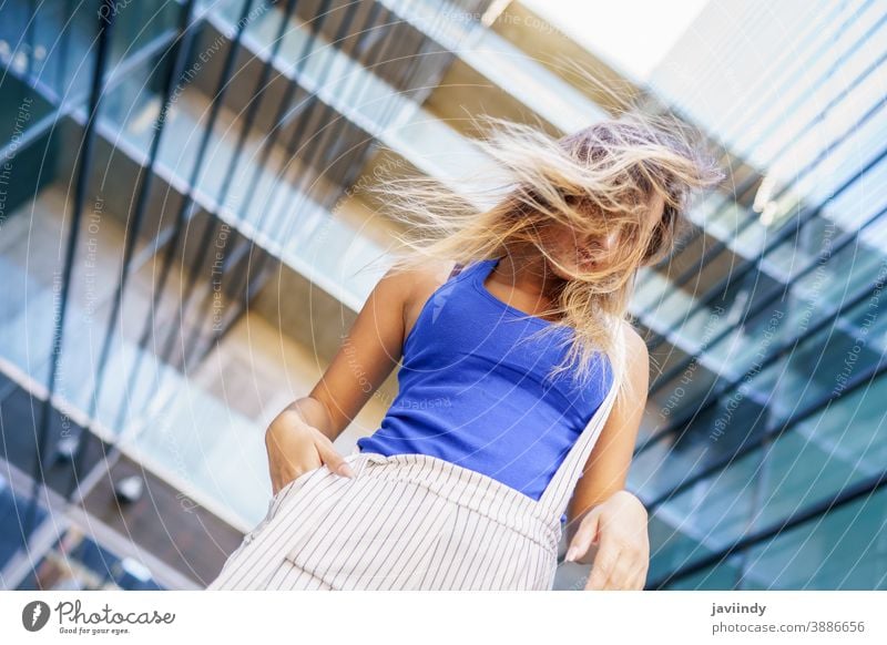 View from above of young girl moving her hair wild female person hairstyle woman beautiful city outdoors lifestyle adult urban happy street modern beauty