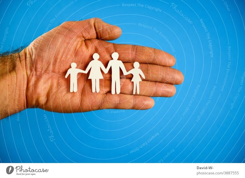 Family planning - hand holds family Domestic happiness Attachment at the same time Love in common concept Together Parents classic family portrait