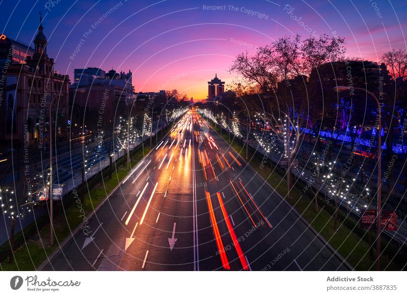 City road with active traffic at night light trail city sunset line glow headlight speed madrid spain evening urban asphalt magnificent motion twilight