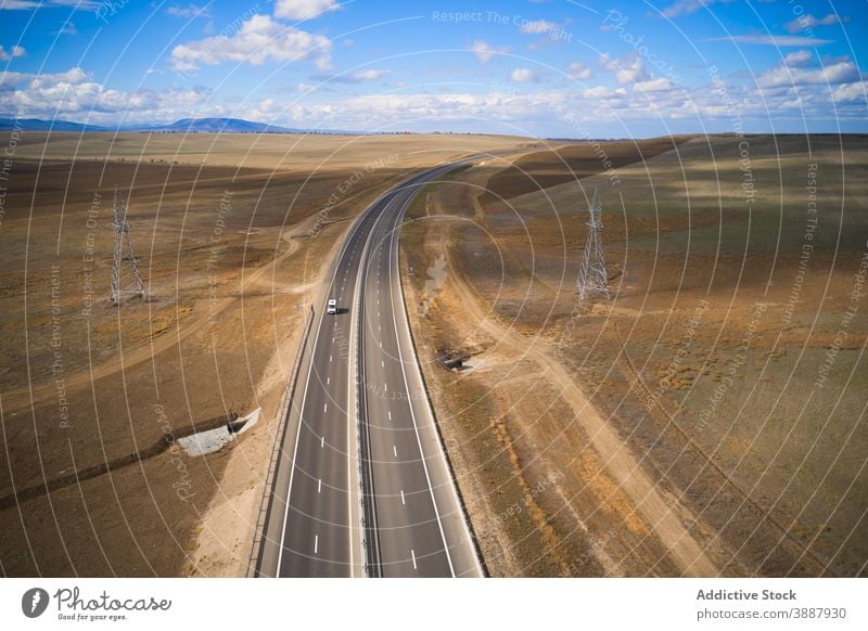 Car driving on road among valley car drive desert nature landscape terrain travel adventure roadway lonely route mountain journey highway environment curve