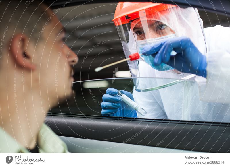 Medical UK NHS worker performing drive-thru COVID-19 test 2019-ncov car check collection contagion contagious control corona coronavirus covid crisis detection