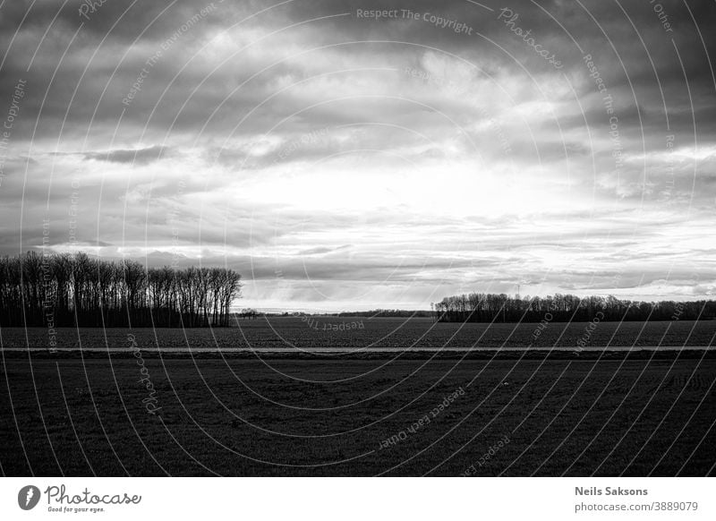 dramatic sky in black and white over the agricultural field Agriculture background balance beautiful blue calmness card cloud color countryside dark dawn day